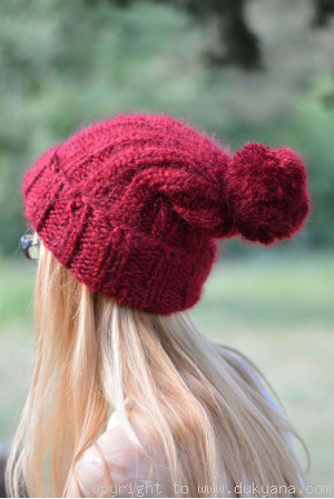 Warm winter ski hat with pompon knitted in red