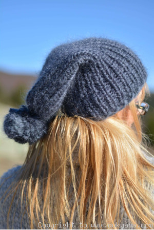 Warm winter ski hat with pompon knitted in denim blue