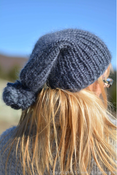 Warm winter ski hat with pompon knitted in denim blue