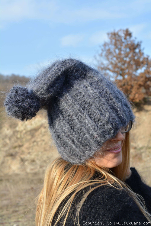 Thick winter ski hat with pompon knitted in dark gray