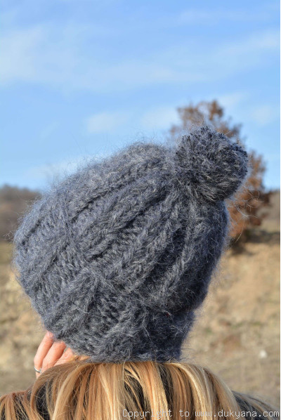 Thick winter ski hat with pompon knitted in dark gray