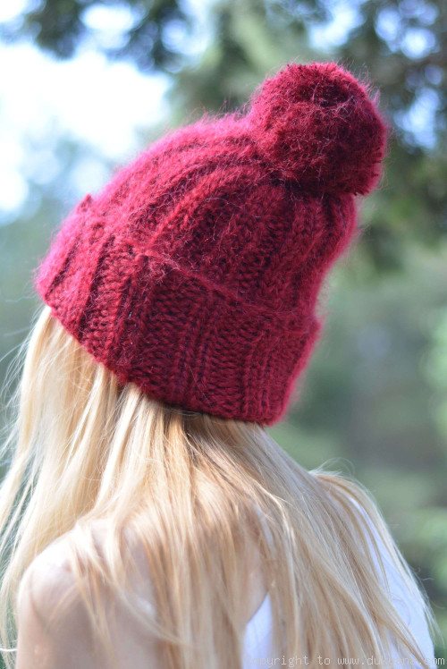 Warm winter ski hat with pompon knitted in red