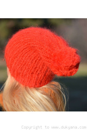 Warm winter ski hat with pompon knitted in bright red